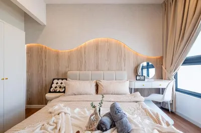 a bedroom with a large bed with a wooden headboard at M Vertica KL Residence Tower E by Feel Home in Kuala Lumpur