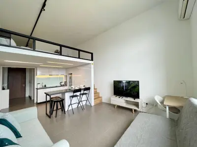 a living room with a couch and a table with a tv at Nana'S at EST Bangsar KL Sentral Gem Loft in Kuala Lumpur