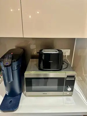 a microwave sitting on a counter next to a blender at Quill Residences Suites KLCC By Dhome in Kuala Lumpur