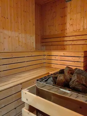 a wooden sauna with rocks in the middle at Quill Residences Suites KLCC By Dhome in Kuala Lumpur