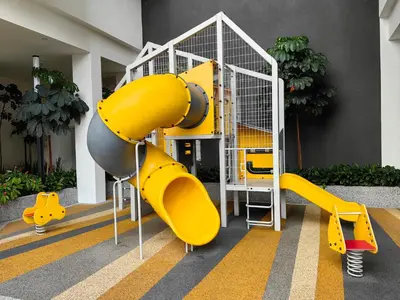 a playground with a yellow slide in a building at Quill Residences Suites KLCC By Dhome in Kuala Lumpur