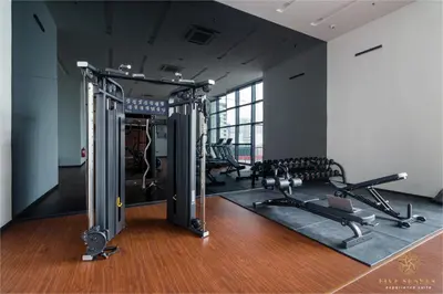 a gym with several treadmills and cardio machines at Chambers Signature Suites, Kuala Lumpur in Kuala Lumpur