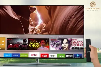 a person holding a wii remote in front of a tv at ViiA Residence, Mid Valley KL in Kuala Lumpur