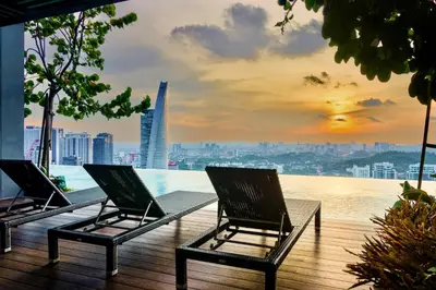 two chairs on a deck with a view of a city at ViiA Residence, Mid Valley KL in Kuala Lumpur