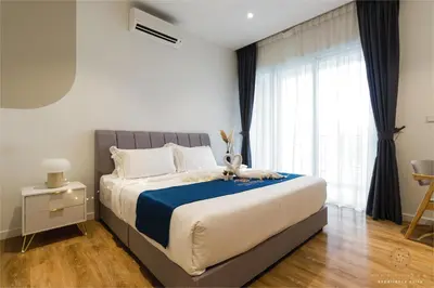 a bedroom with a bed and a large window at Quill City Residences KLCC, Five Senses in Kuala Lumpur