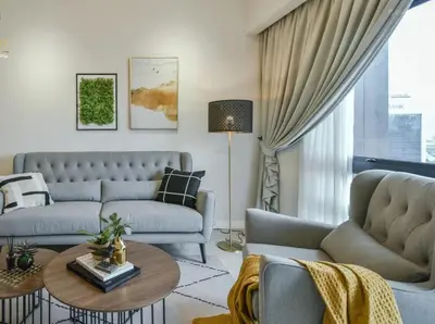 a living room with two couches and a table at Anggun Residences KLCC by LuxLofts in Kuala Lumpur