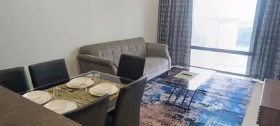 a living room with a table and a couch at Anggun Residences KLCC by LuxLofts in Kuala Lumpur