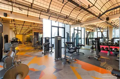a gym with several treadmills and exercise equipment at Scarletz Signature Suites, KLCC in Kuala Lumpur