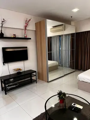 a living room with a flat screen tv and a couch at Summer Suites KLCC By Homestay in Kuala Lumpur