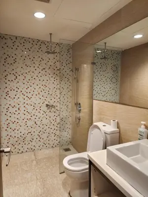 a bathroom with a toilet and a shower and a sink at Regalia Comfort Suites KLCC SkyPool in Kuala Lumpur
