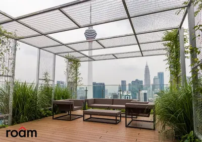 a rooftop patio with a view of the city at Ceylonz Signature Suites, Bukit Bintang in Kuala Lumpur
