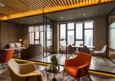 a lobby with chairs and tables and windows at Ceylonz Signature Suites, Bukit Bintang in Kuala Lumpur