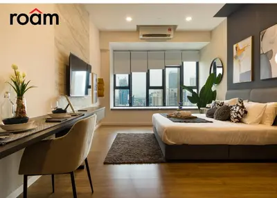 a bedroom with a bed and a table and a desk at Ceylonz Signature Suites, Bukit Bintang in Kuala Lumpur