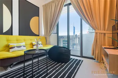 a living room with a yellow couch and a table at The Colony & The Luxe Signature Suites, KLCC in Kuala Lumpur