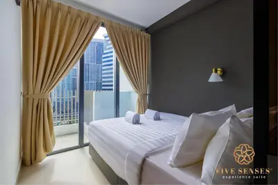 a bedroom with a bed and a large window at The Colony & The Luxe Signature Suites, KLCC in Kuala Lumpur