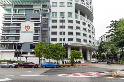 a tall white building with cars parked in front of it at Dua Sentral Signature Suites in Kuala Lumpur