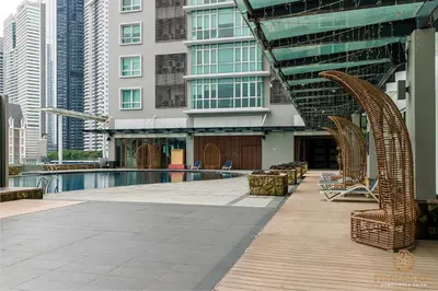 a swimming pool in a city with tall buildings at Dua Sentral Signature Suites in Kuala Lumpur