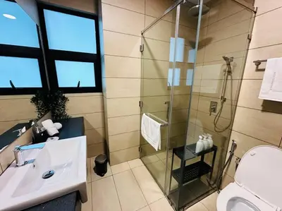a bathroom with a shower and a sink and a toilet at Opus Residence KL 118 Chinatown by \u54c1\u5c4b PINWU Shortstay in Kuala Lumpur