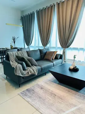 a living room with a blue couch and a table at Opus Residence KL 118 Chinatown by \u54c1\u5c4b PINWU Shortstay in Kuala Lumpur
