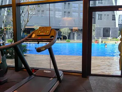 a gym with a view of a swimming pool at Arte Mont Kiara MITEC Publika MATRADE kuala lumpur 1R2B 4 Pax in Kuala Lumpur