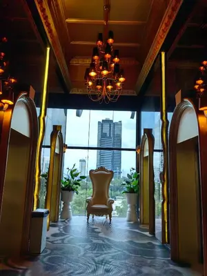 a lobby with a chair and a large window at Arte Mont Kiara MITEC Publika MATRADE kuala lumpur 1R2B 4 Pax in Kuala Lumpur