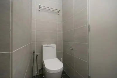 a bathroom with a white toilet and a shower at Cozy Skyline Retreat at Trion KL, Level 63 in Kuala Lumpur