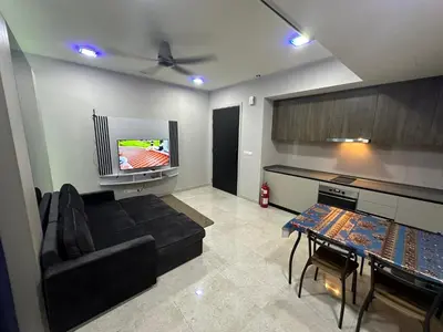 a living room with a couch and a flat screen tv at Datum Jelatek Sky Resident KLCC by Deen in Kuala Lumpur