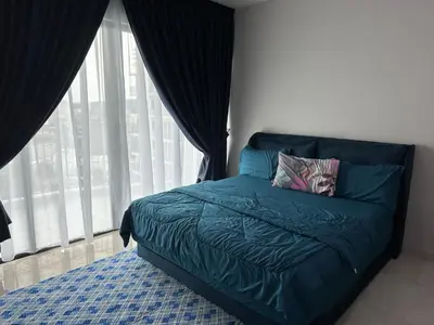 a bedroom with a blue bed with a large window at Datum Jelatek Sky Resident KLCC by Deen in Kuala Lumpur