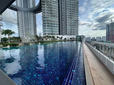a swimming pool in a city with tall buildings at Datum Jelatek Sky Resident KLCC by Deen in Kuala Lumpur