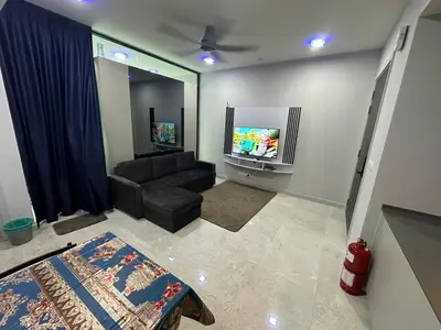 a living room with a couch and a flat screen tv at Datum Jelatek Sky Resident KLCC by Deen in Kuala Lumpur