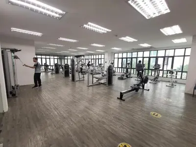a man working out in a gym with weights at Legasi Al Rahmat Kampung Baru in Kuala Lumpur