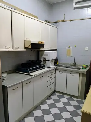 a kitchen with white cabinets and a checkered floor at EMPRESS SIGNATURE in Kuala Lumpur
