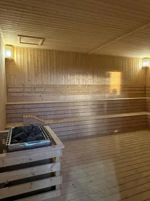 a empty sauna with a stove in the middle at Trion KL Family Condotel TRX KLCC MRT in Kuala Lumpur