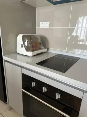 a kitchen with a toaster sitting on a counter at Trion KL Family Condotel TRX KLCC MRT in Kuala Lumpur