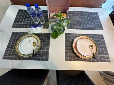 a table with two plates and water bottles on it at Trion KL Family Condotel TRX KLCC MRT in Kuala Lumpur