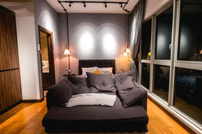 a living room with a couch in a room at Modern Studio @ Kuala Lumpur, Regalia Residence in Kuala Lumpur