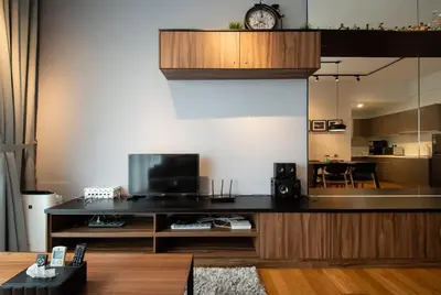 a living room with a table with a clock on it at Modern Studio @ Kuala Lumpur, Regalia Residence in Kuala Lumpur