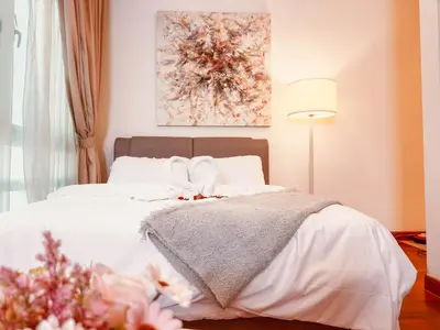a bedroom with a white bed with a bow on it at 6 PAX, Studio, 3mins to KLCC (3A01) in Kuala Lumpur