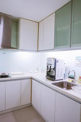 a kitchen with white cabinets and a sink at 6 PAX, Studio, 3mins to KLCC (3A01) in Kuala Lumpur