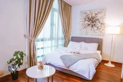 a bedroom with a bed with a table and a window at 6 PAX, Studio, 3mins to KLCC (3A01) in Kuala Lumpur