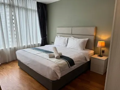 a bedroom with a bed with a towel on it at Vortex Suites KLCC By SALEH in Kuala Lumpur