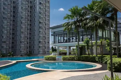 a swimming pool in front of a building with tall buildings at V Residence at Sunway Velocity by MY TRIP & MY STAY in Kuala Lumpur