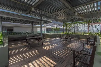 a patio with two benches and a table and chairs at V Residence at Sunway Velocity by MY TRIP & MY STAY in Kuala Lumpur