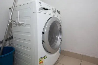 a white washing machine in a room with a bucket at V Residence at Sunway Velocity by MY TRIP & MY STAY in Kuala Lumpur