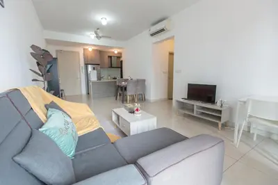 a living room with a gray couch and a kitchen at V Residence at Sunway Velocity by MY TRIP & MY STAY in Kuala Lumpur
