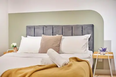 a bedroom with a large bed with white pillows at Continew Residence TRX KL in Kuala Lumpur