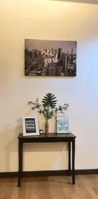 a table in a room with two pictures on it at Regalia Suites with Infinity Pool KLCC by Staycation Homes in Kuala Lumpur