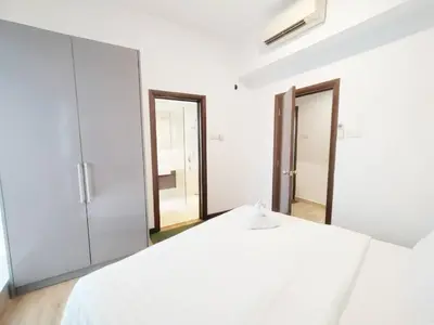 a white bedroom with a large white bed and mirrors at Regalia Suites with Infinity Pool KLCC by Staycation Homes in Kuala Lumpur