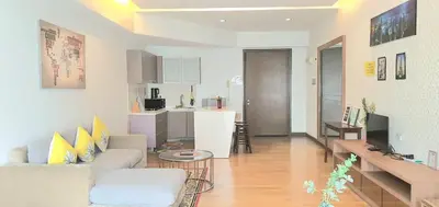 a living room with a couch and a kitchen at Regalia Suites with Infinity Pool KLCC by Staycation Homes in Kuala Lumpur