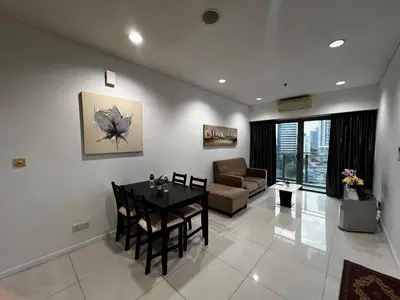 a living room with a table and a couch at Mercu summer Suites by KL Residence in Kuala Lumpur
